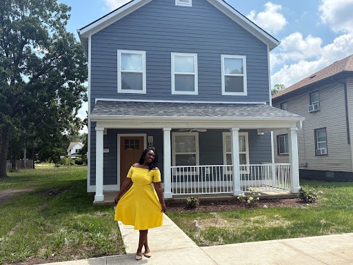 Alicia posing in front of her new home!