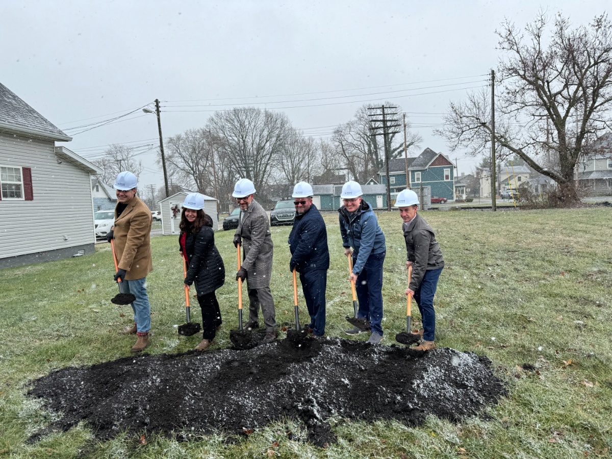 team breaking ground in Shelbyville, IN - holding shovels with dirt