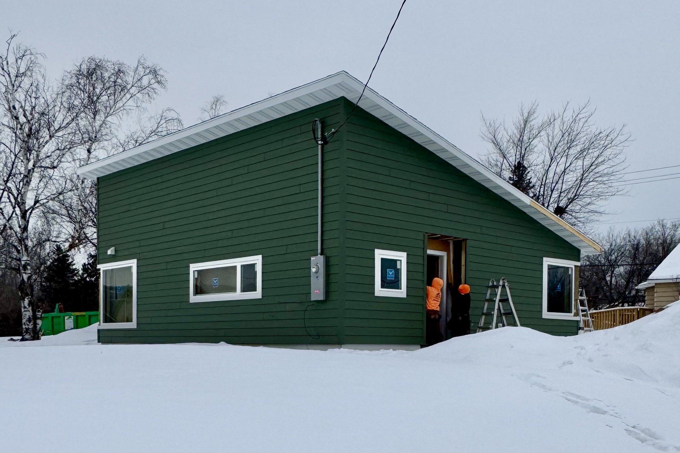 Exterior finishing touches happen on a thoughtfully designed home by One Roof Community Housing in Duluth, MN.